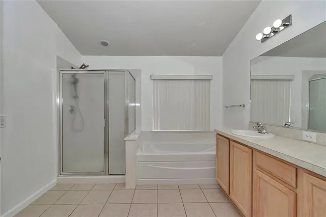 a bathroom with a granite countertop sink a mirror and a bathtub
