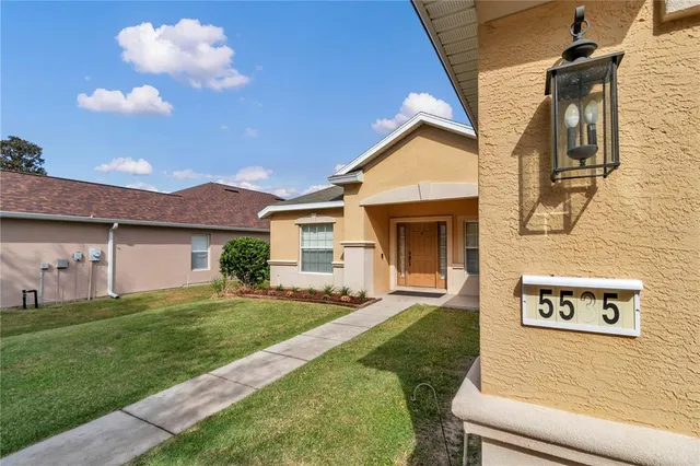 a view of a house with a yard and a garden