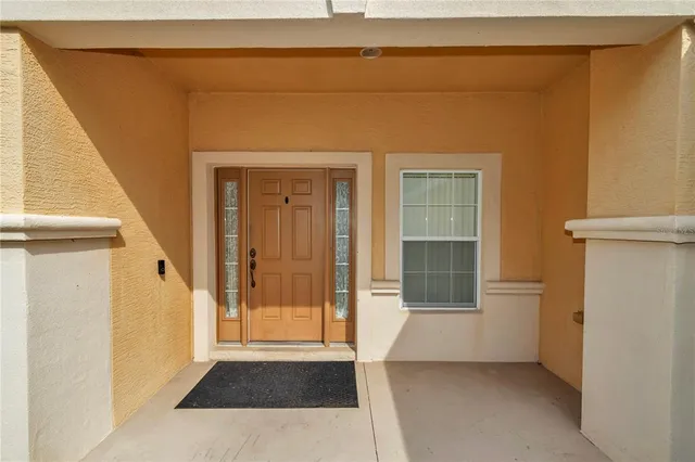 a view of an entryway door with a hallway