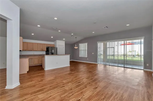 a view of kitchen with kitchen island wooden floor and window