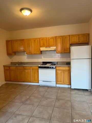 a kitchen with a stove a sink and a refrigerator