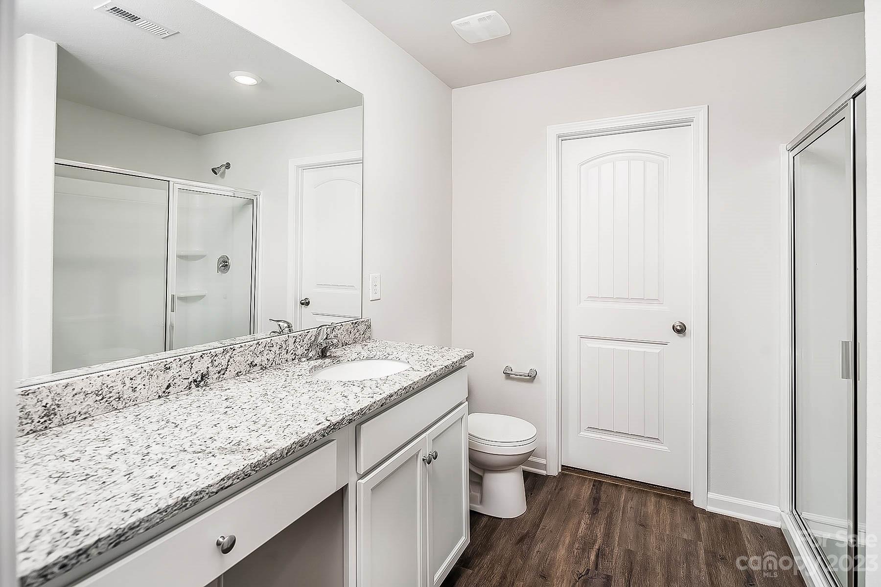 1620 Nia Road Charlotte, NC 28215 - Photo 11 of 14 a bathroom with a granite countertop sink a toilet and shower