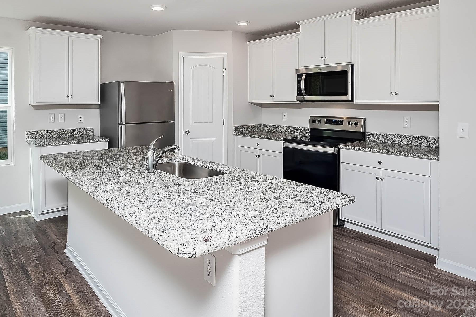 1620 Nia Road Charlotte, NC 28215 - Photo 2 of 14 a kitchen with appliances a sink and a refrigerator