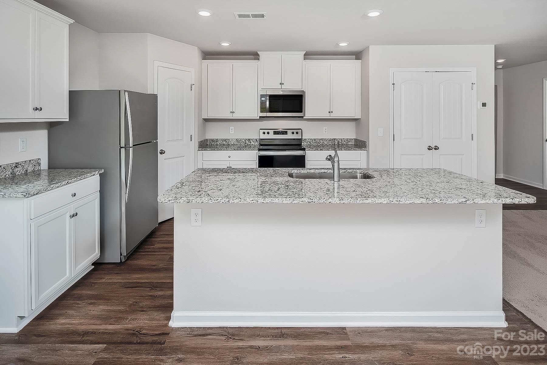 1620 Nia Road Charlotte, NC 28215 - Photo 4 of 14 a kitchen with stainless steel appliances granite countertop a refrigerator a stove a sink and white cabinets