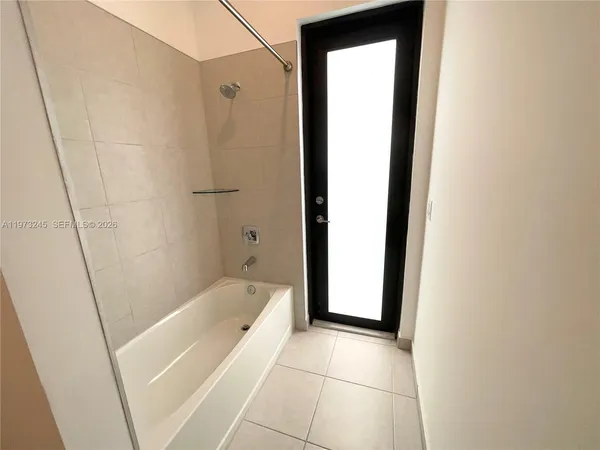 a bathroom with a bathtub and shower