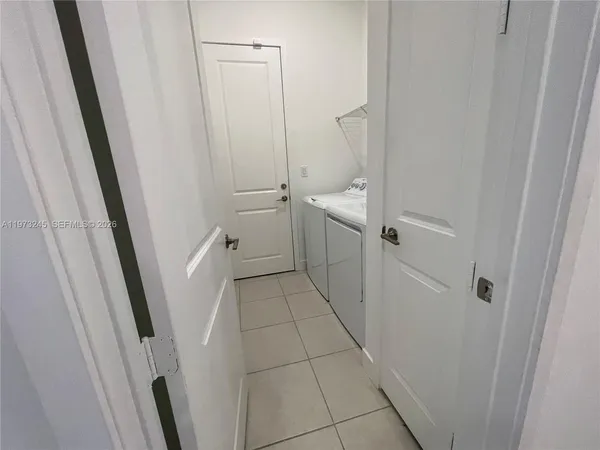 a view of a hallway with a kitchen