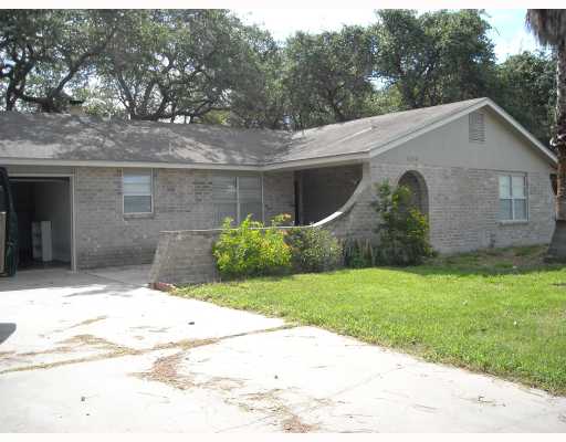 a backyard of a house with plants and trees