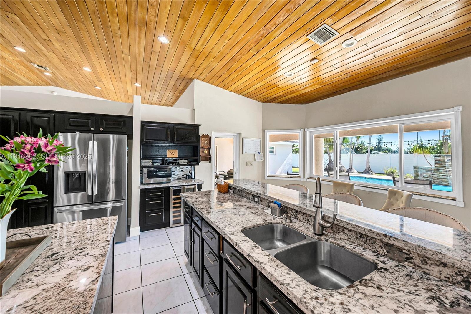 10700 Southwest 139th Road Miami, FL 33176 - Photo 33 of 68 a kitchen with granite countertop a sink a counter top space and stainless steel appliances