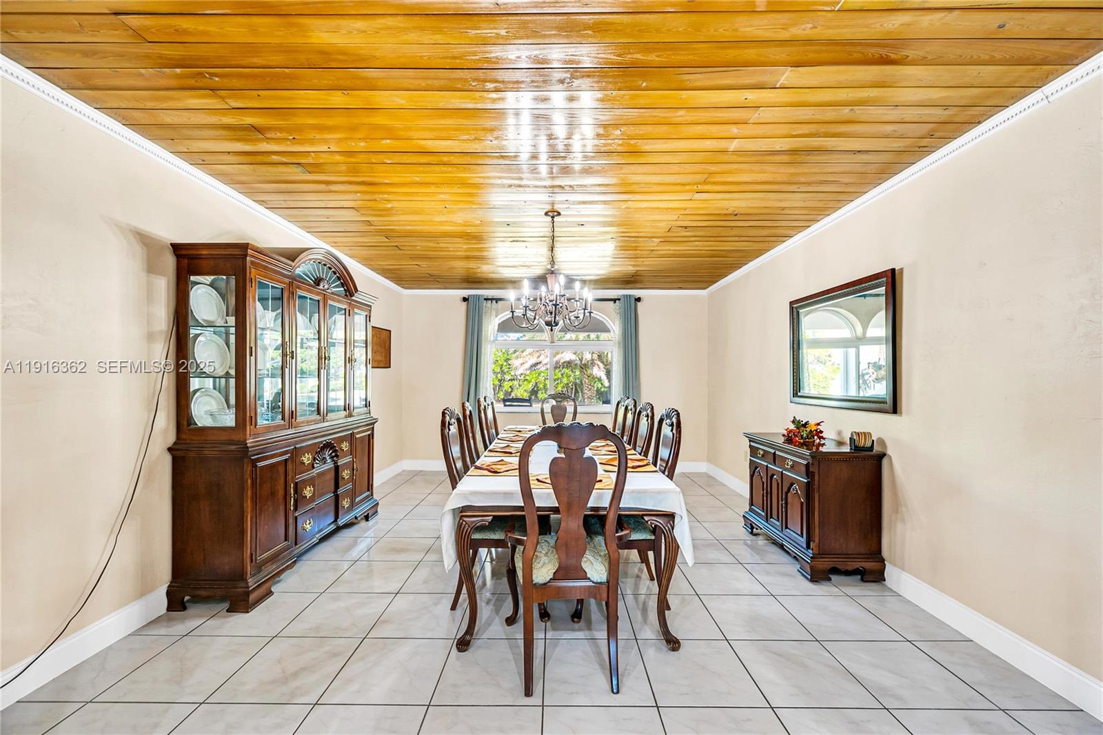 10700 Southwest 139th Road Miami, FL 33176 - Photo 35 of 68 a view of a dining room with furniture and chandelier