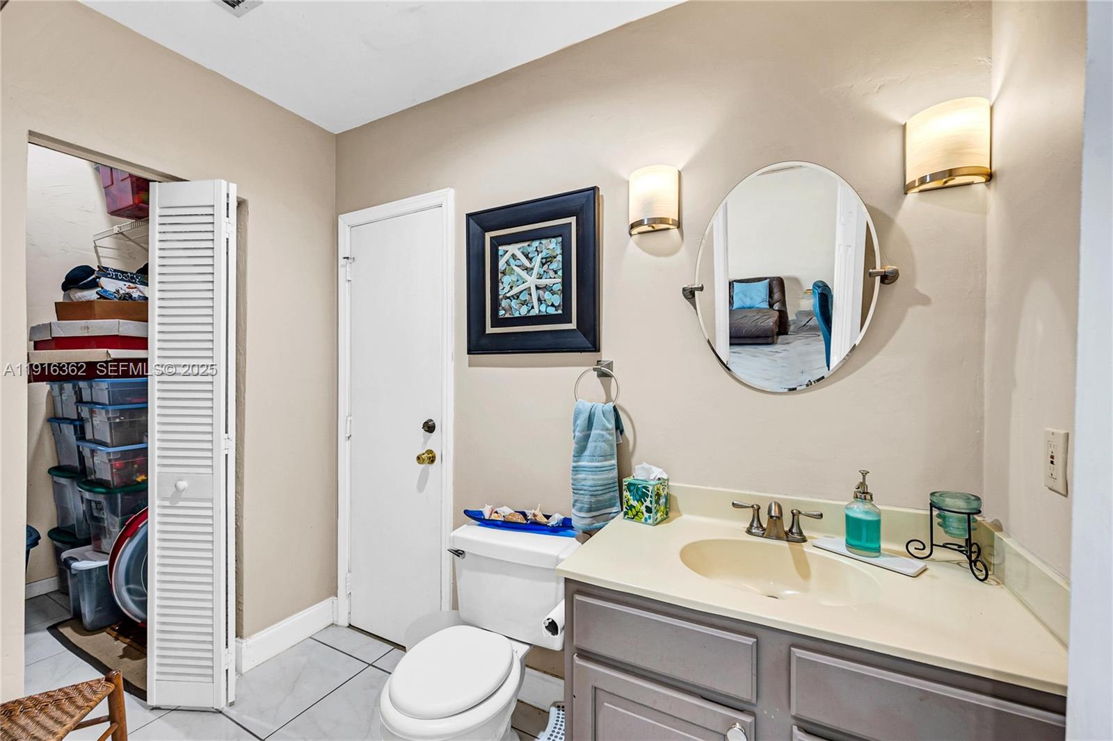 10700 Southwest 139th Road Miami, FL 33176 - Photo 37 of 68 a bathroom with a toilet a sink and a mirror