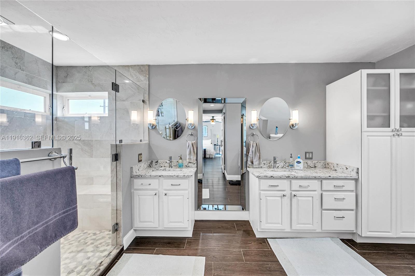 10700 Southwest 139th Road Miami, FL 33176 - Photo 44 of 68 a large bathroom with a double vanity sink a mirror and a shower