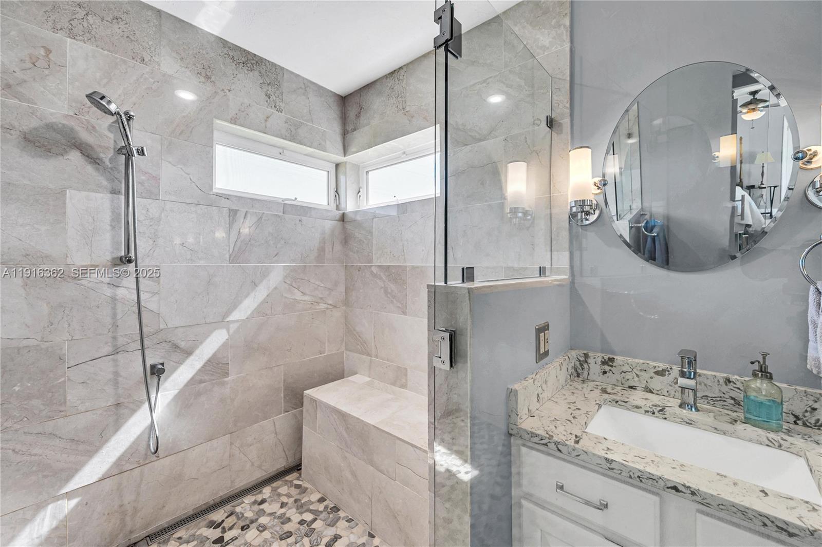 10700 Southwest 139th Road Miami, FL 33176 - Photo 46 of 68 a bathroom with a granite countertop sink mirror and shower