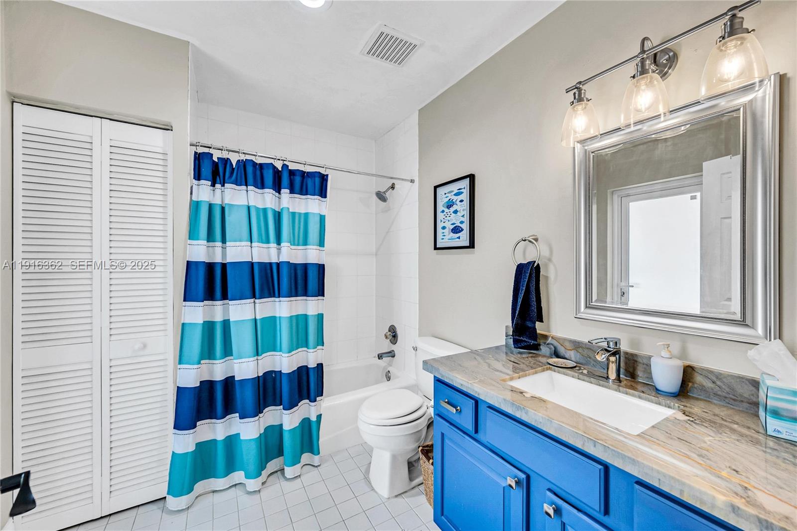 10700 Southwest 139th Road Miami, FL 33176 - Photo 48 of 68 a bathroom with a sink a toilet and shower curtain