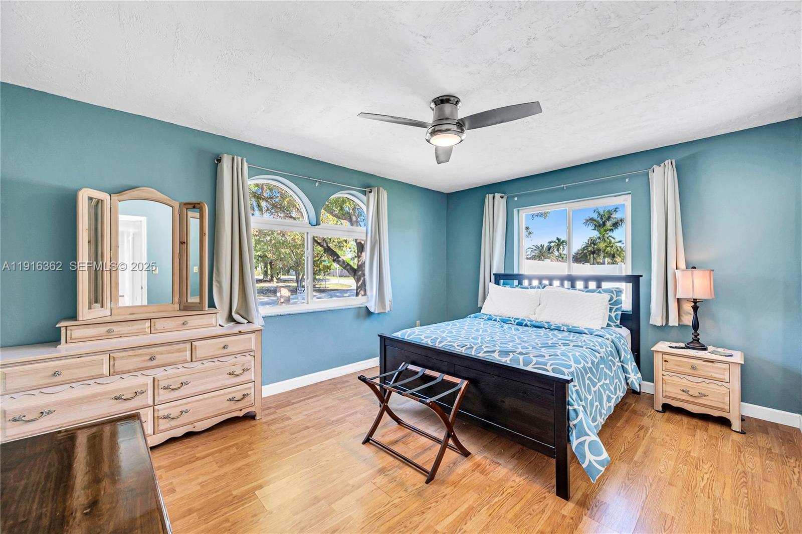 10700 Southwest 139th Road Miami, FL 33176 - Photo 52 of 68 a bedroom with a bed a dresser next to a window