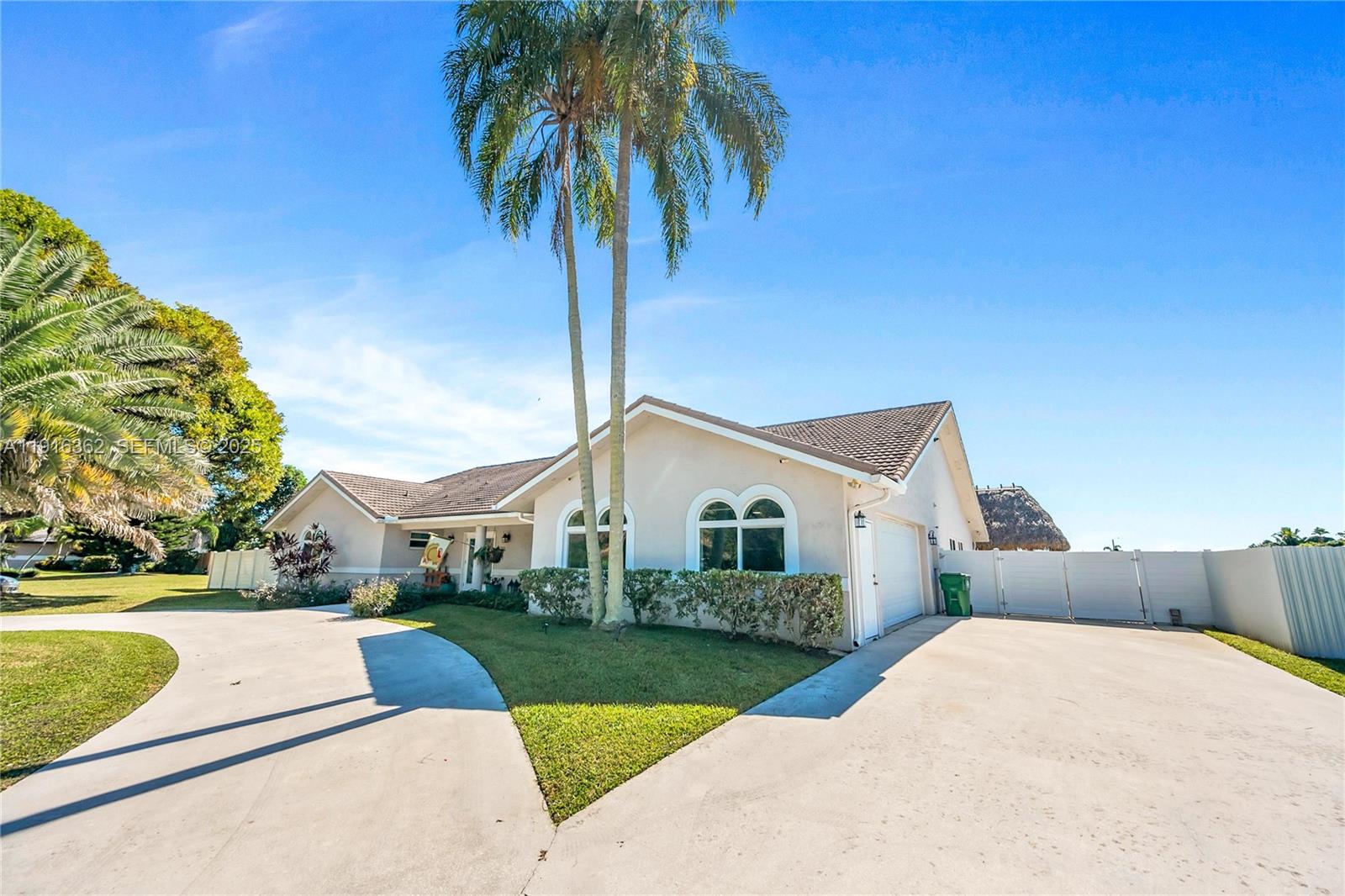 10700 Southwest 139th Road Miami, FL 33176 - Photo 8 of 68 a front view of a house with a yard and garage