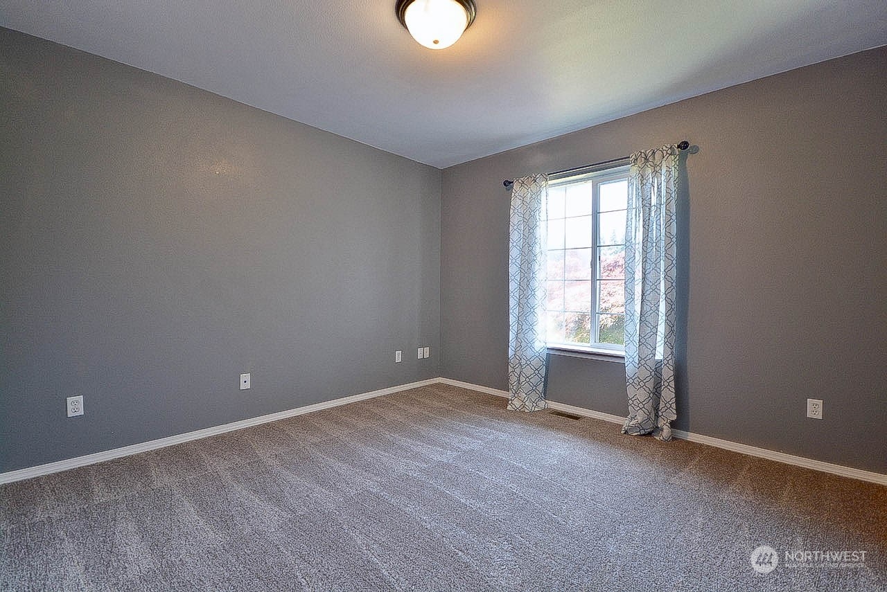 10306 3rd Street Southeast Yelm, WA 98597 - Photo 11 of 21 wooden floor and window in an empty room