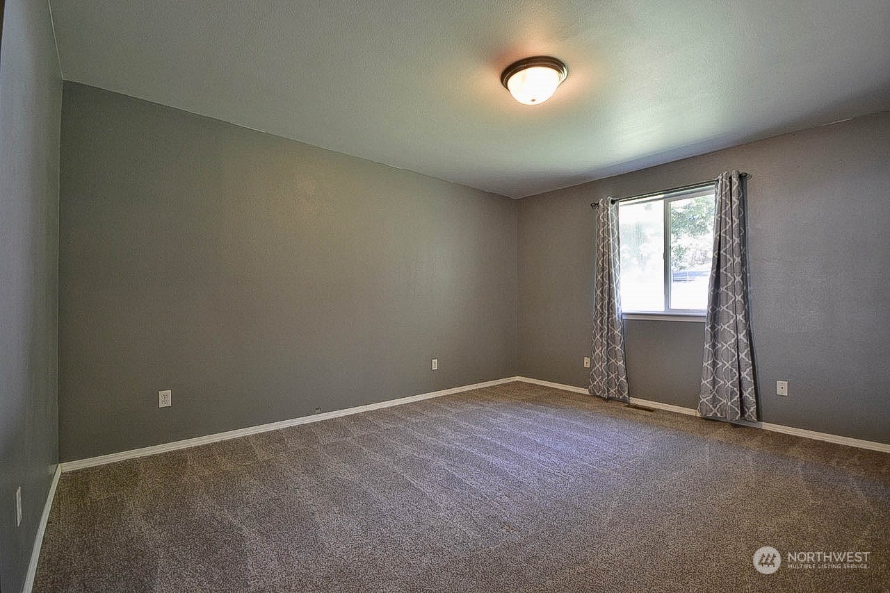 10306 3rd Street Southeast Yelm, WA 98597 - Photo 13 of 21 an empty room with a empty space and windows