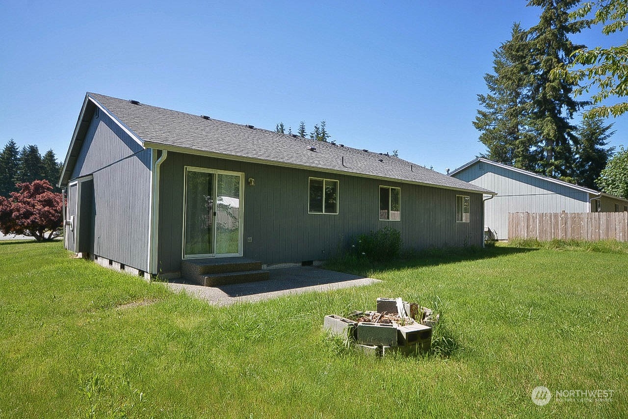 10306 3rd Street Southeast Yelm, WA 98597 - Photo 18 of 21 a backyard of a house with table and chairs