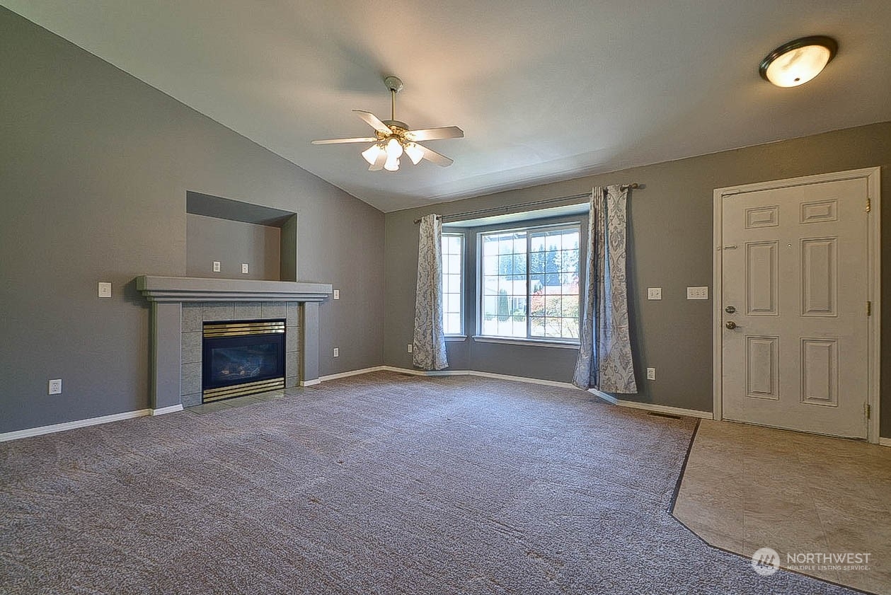 10306 3rd Street Southeast Yelm, WA 98597 - Photo 5 of 21 wooden floor fireplace and windows in an empty room