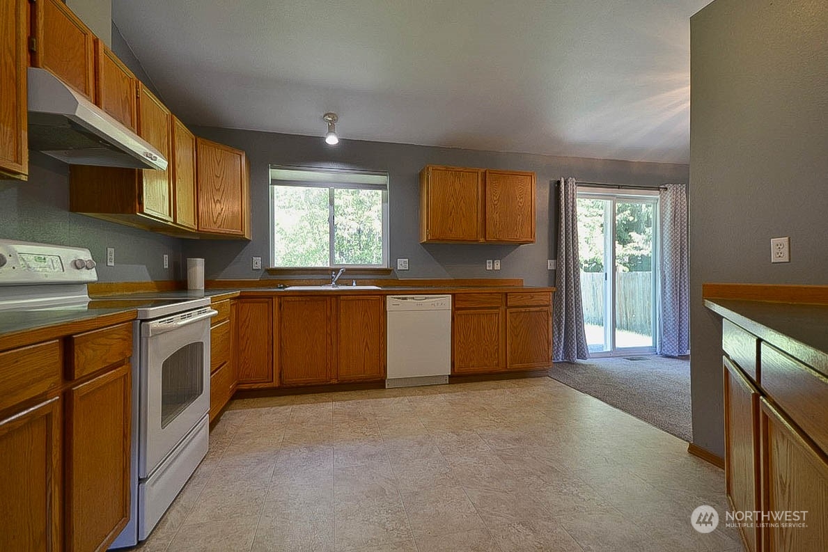 10306 3rd Street Southeast Yelm, WA 98597 - Photo 10 of 21 a kitchen with stainless steel appliances a sink stove and cabinets