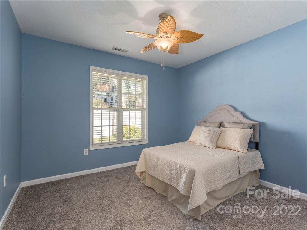 16 Village Street Clyde, NC 28721 - Photo 12 of 21 a bedroom with a bed and a chandelier