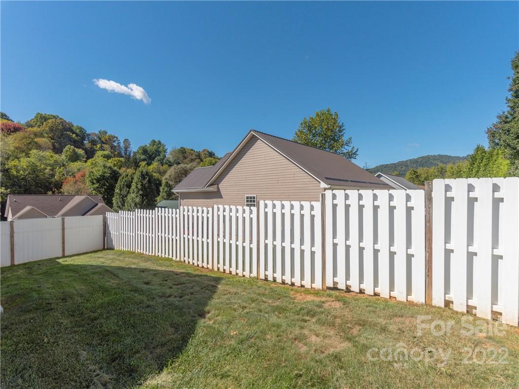 16 Village Street Clyde, NC 28721 - Photo 19 of 21 a view of a garden with a small yard