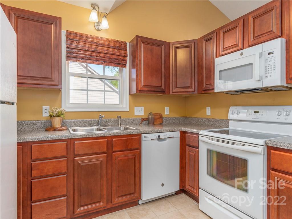 16 Village Street Clyde, NC 28721 - Photo 5 of 21 a kitchen with cabinets appliances a sink and a window