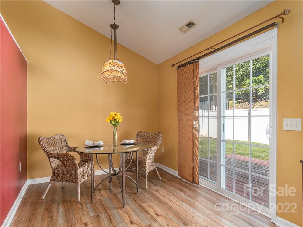 16 Village Street Clyde, NC 28721 - Photo 7 of 21 a view of a dining room with furniture wooden floor and a chandelier