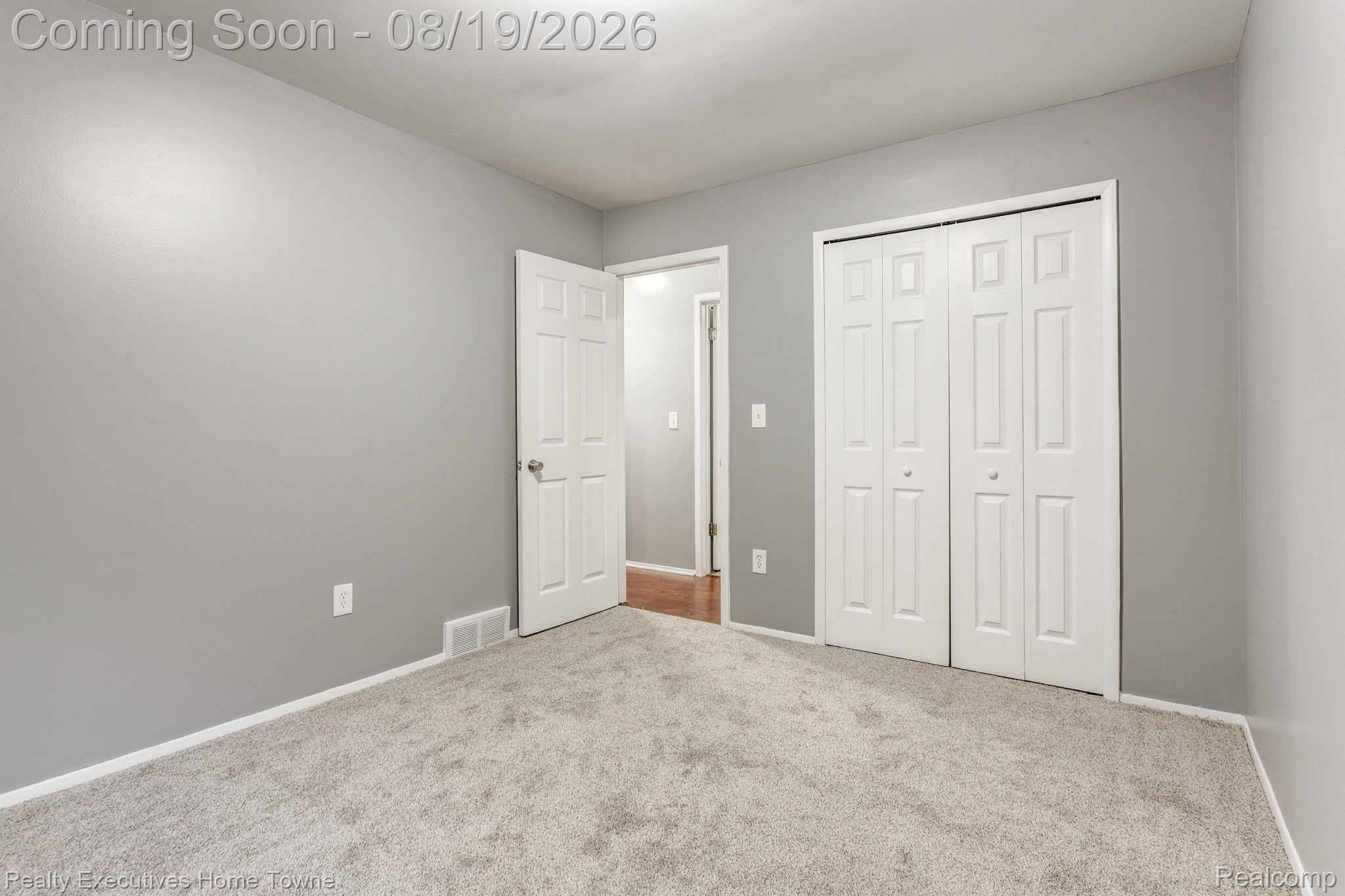 2448 Oakcrest Road Sterling Heights, MI 48310 - Photo 18 of 31 Plush carpet flooring, neutral paint palette, white trim, and bi-fold closet doors