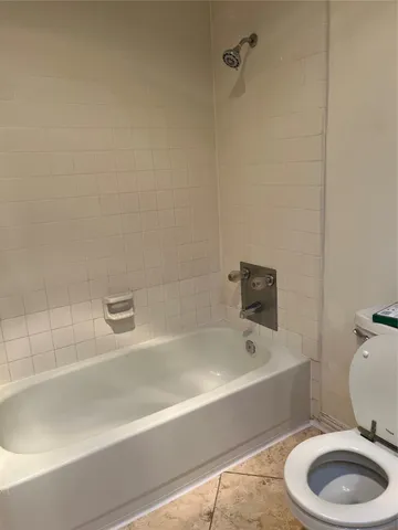 a bathroom with a sink a toilet and bathtub
