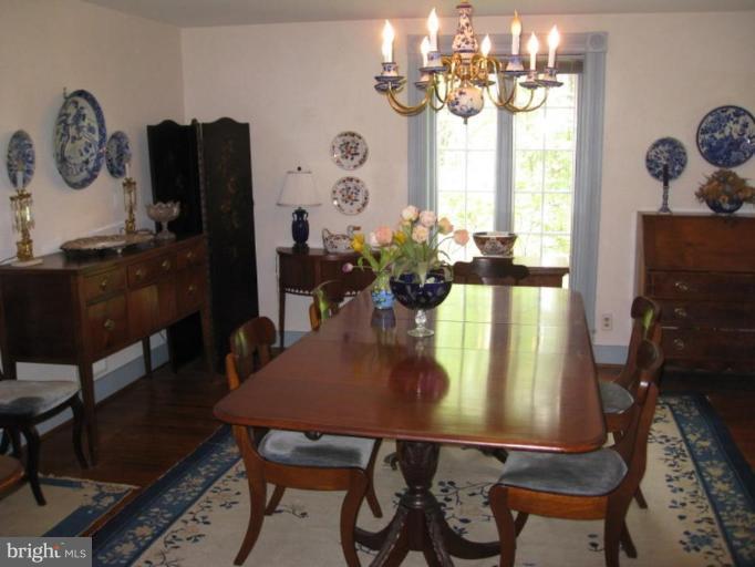 11811 Ridgemont Road Lutherville-Timonium, MD 21093 - Photo 13 of 17 a view of a dining room with furniture and chandelier