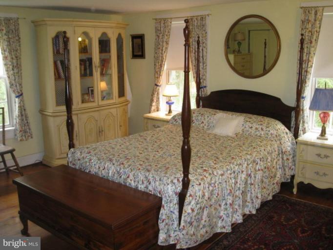11811 Ridgemont Road Lutherville-Timonium, MD 21093 - Photo 14 of 17 a bedroom with a bed and a mirror