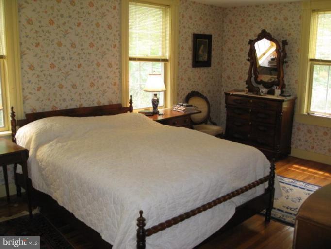 11811 Ridgemont Road Lutherville-Timonium, MD 21093 - Photo 3 of 17 a bedroom with a bed and dresser with mirror