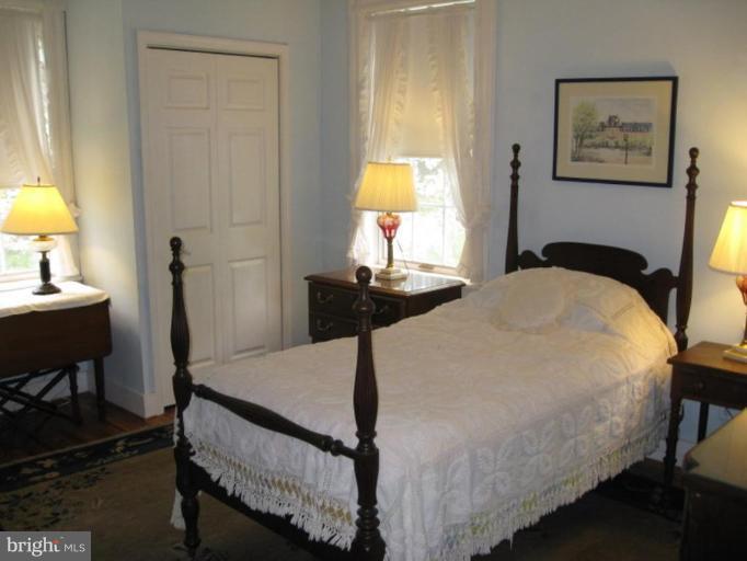 11811 Ridgemont Road Lutherville-Timonium, MD 21093 - Photo 4 of 17 a bedroom with a bed and a table in it
