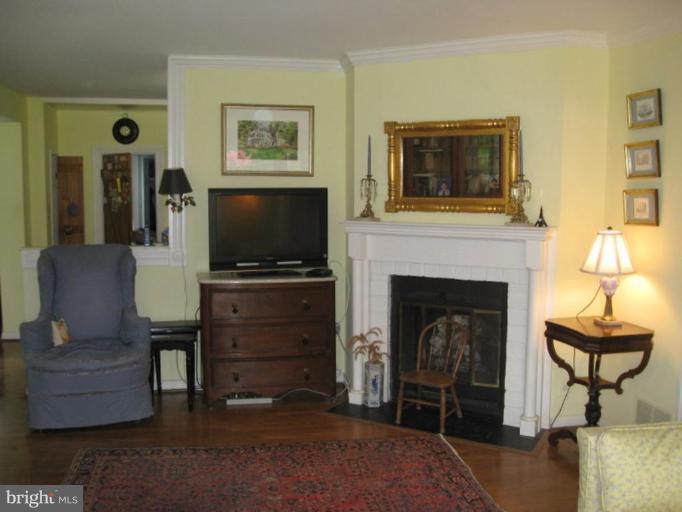 11811 Ridgemont Road Lutherville-Timonium, MD 21093 - Photo 7 of 17 a living room with furniture and a fireplace
