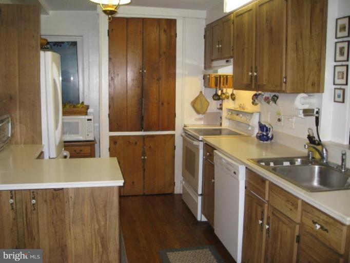 11811 Ridgemont Road Lutherville-Timonium, MD 21093 - Photo 8 of 17 a kitchen with a sink and wooden cabinets