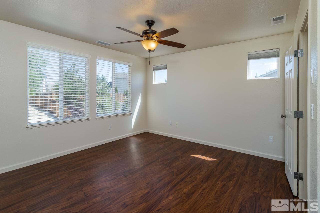 981 South University Reno, NV 89512 - Photo 14 of 19 a view of an empty room with wooden floor and a window