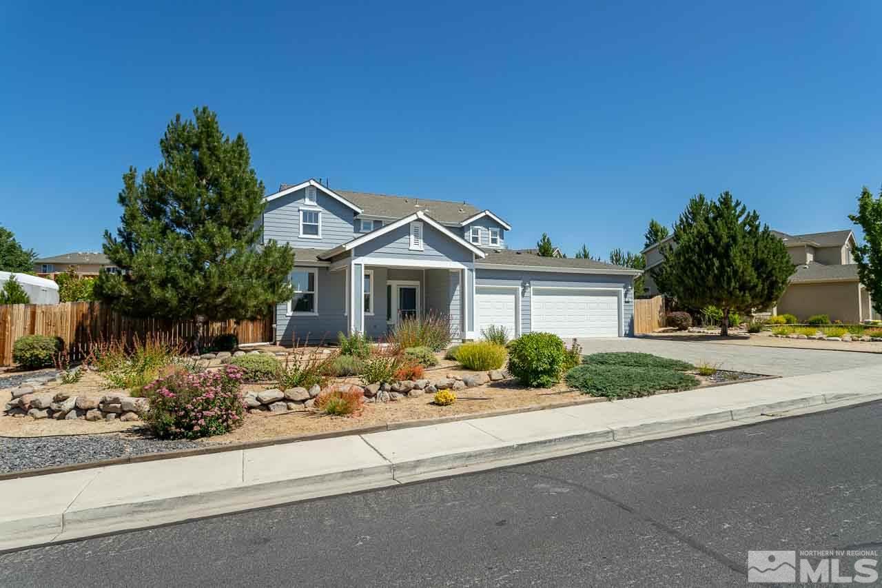 981 South University Reno, NV 89512 - Photo 3 of 19 a front view of a house with a yard and garage