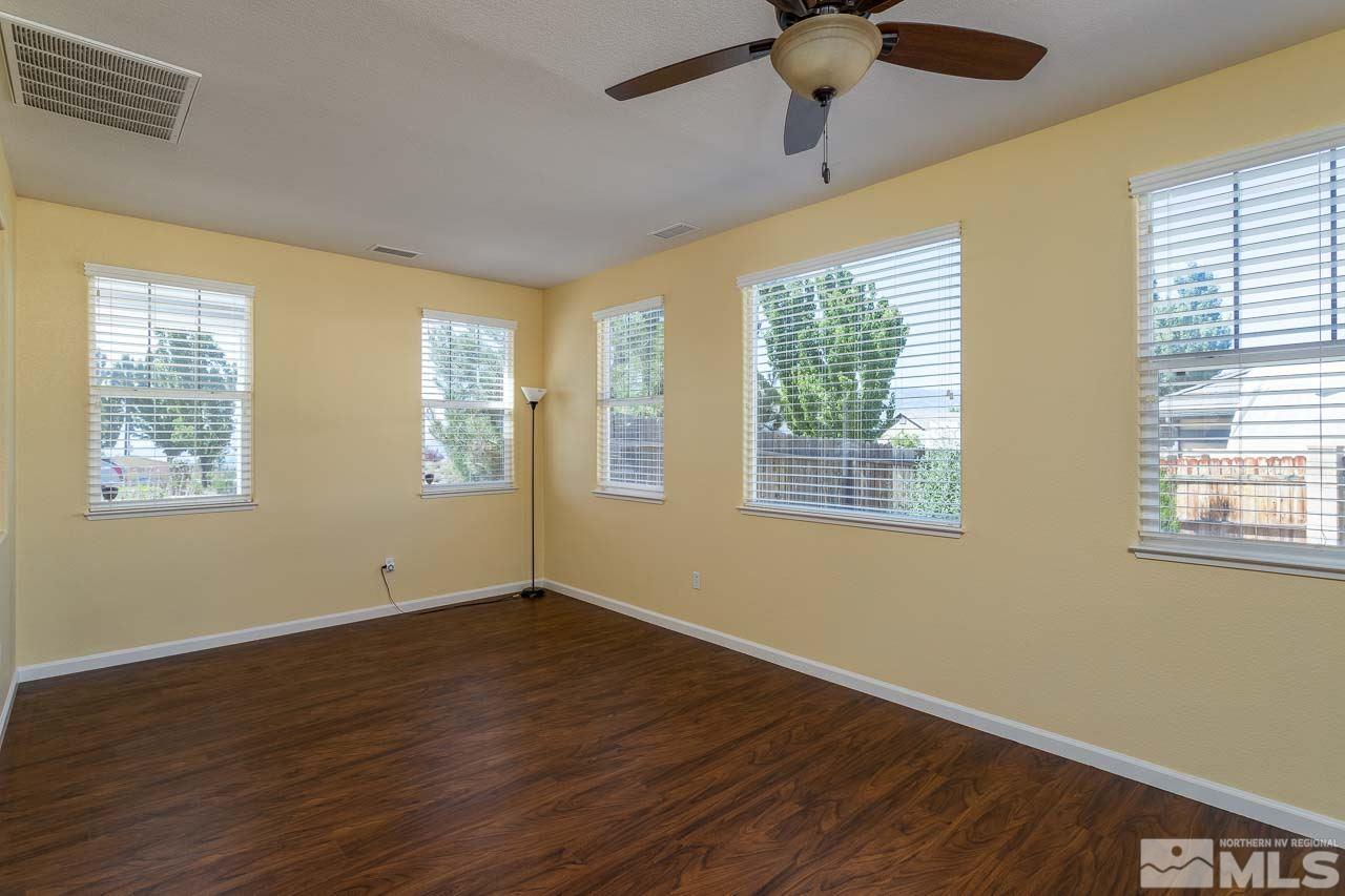 981 South University Reno, NV 89512 - Photo 4 of 19 a view of an empty room with wooden floor and a window
