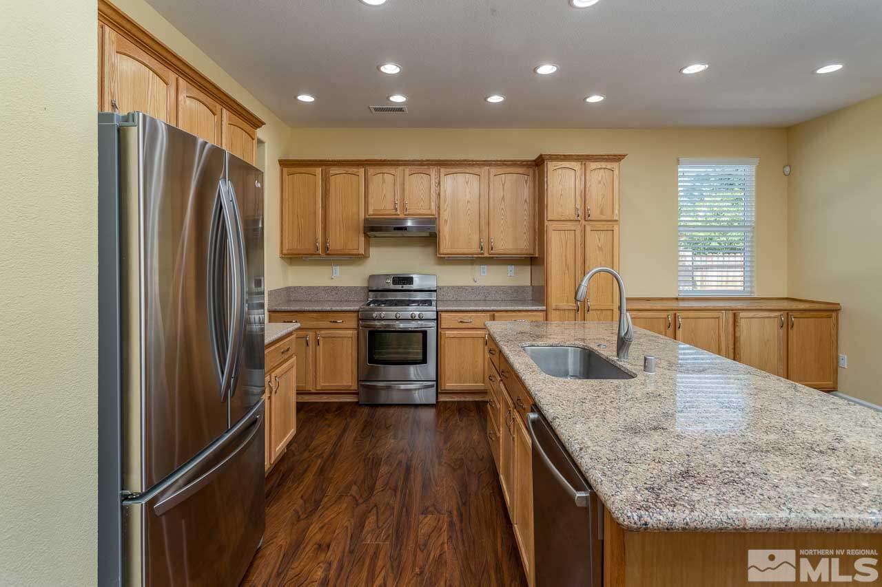981 South University Reno, NV 89512 - Photo 7 of 19 a kitchen with kitchen island granite countertop a sink appliances cabinets and counter space
