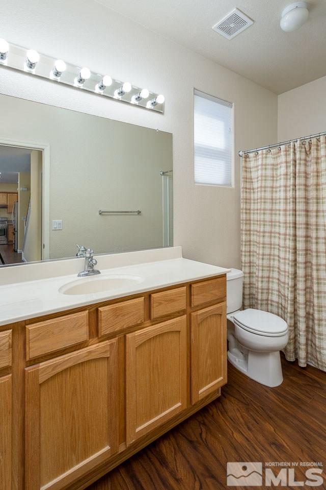 981 South University Reno, NV 89512 - Photo 9 of 19 a bathroom with a toilet sink and mirror