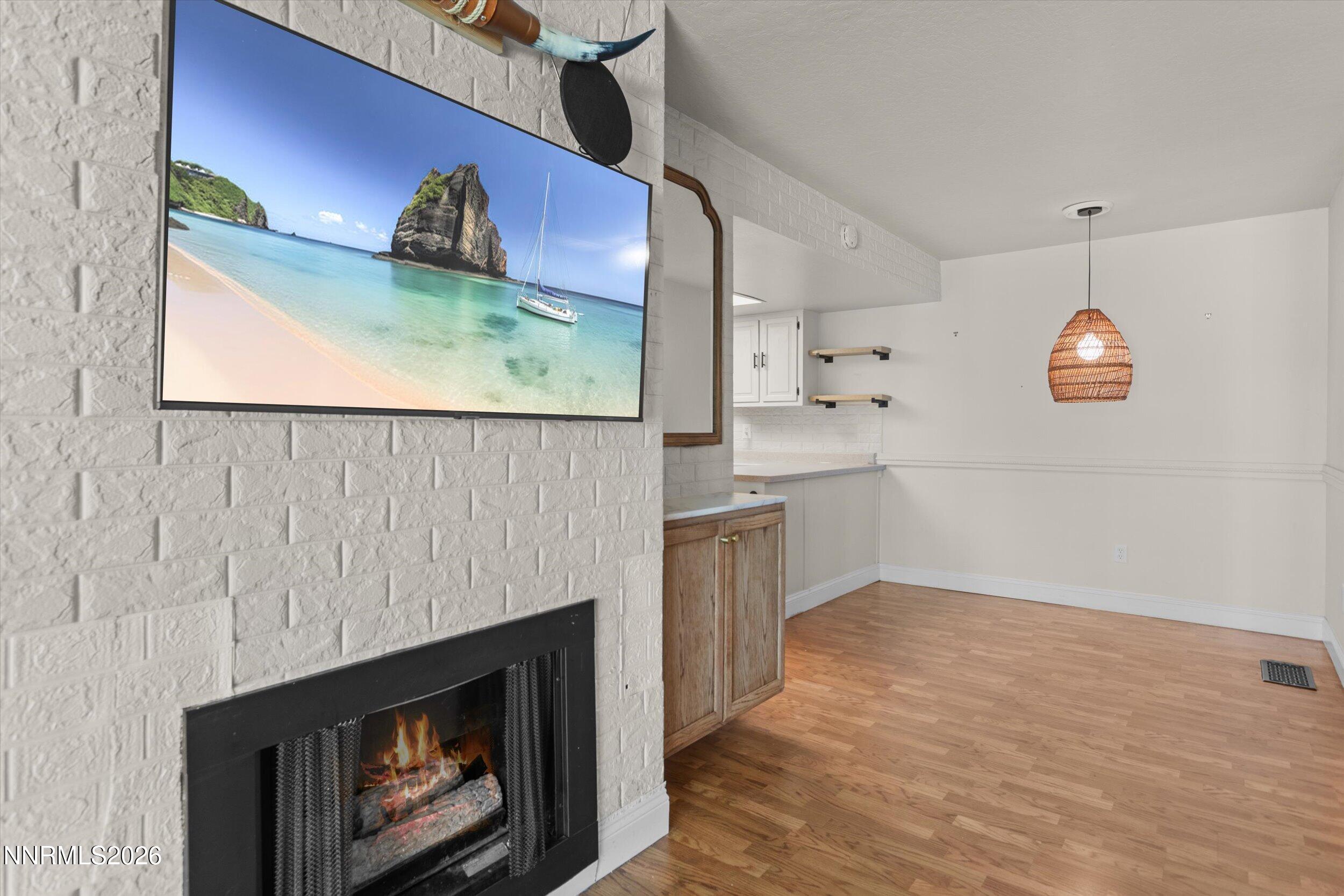 2300 Dickerson Road, Unit 51 Reno, NV 89503 - Photo 17 of 46 an empty room with wooden floor and fireplace