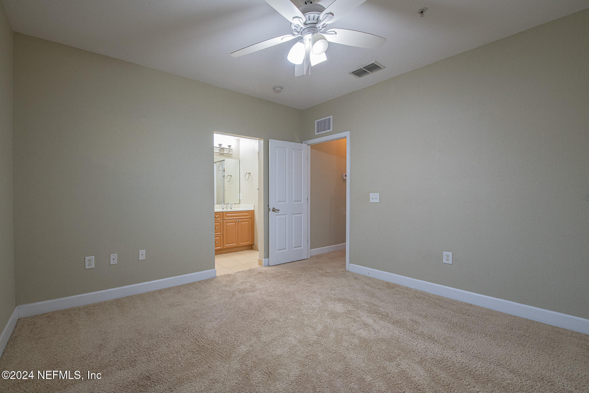 9745 Touchton Road, Unit 1922 Jacksonville, FL 32246 - Photo 18 of 26 an empty room with a chandelier fan and windows