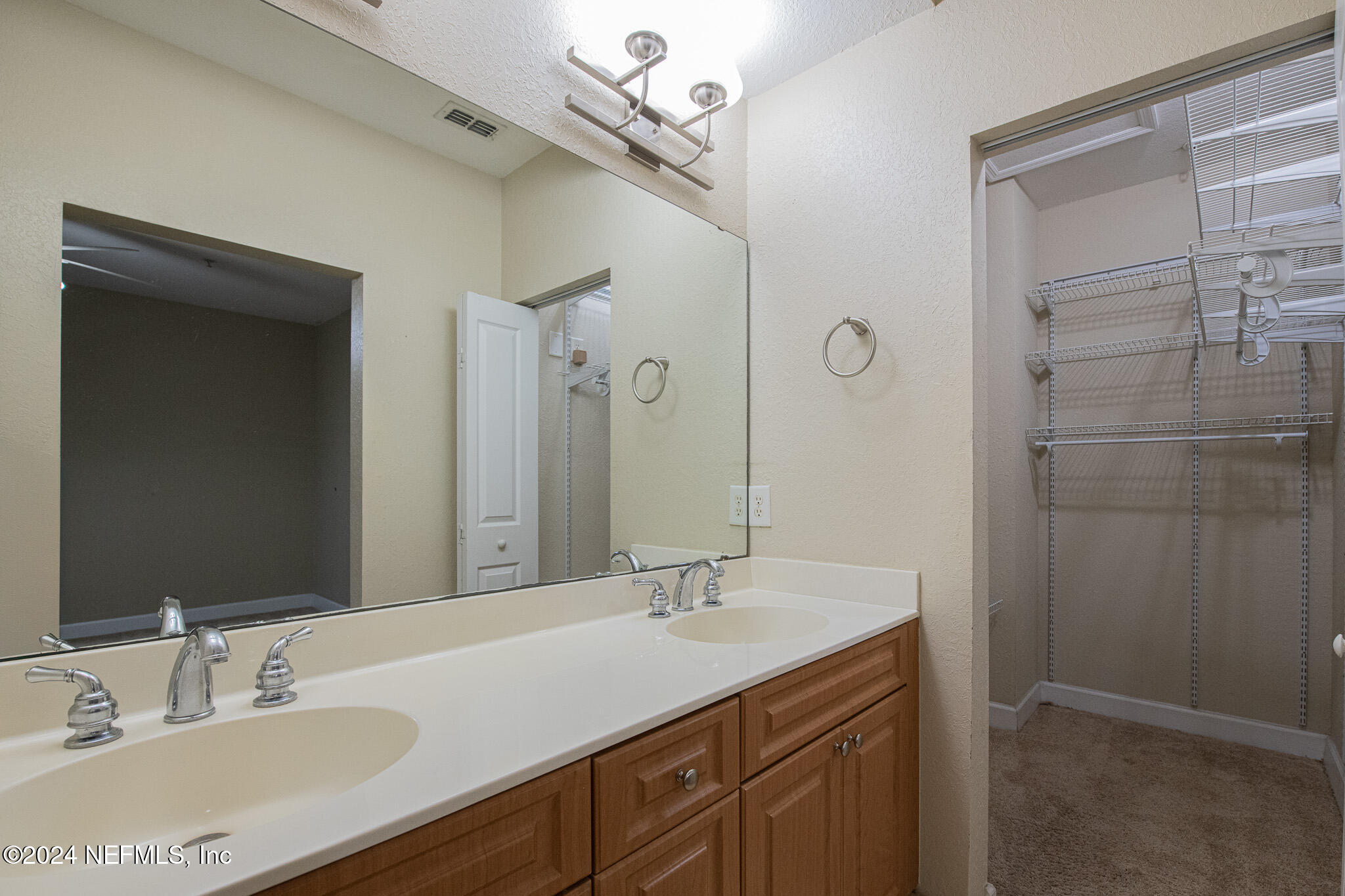 9745 Touchton Road, Unit 1922 Jacksonville, FL 32246 - Photo 20 of 26 a bathroom with a granite countertop sink a shower and a mirror