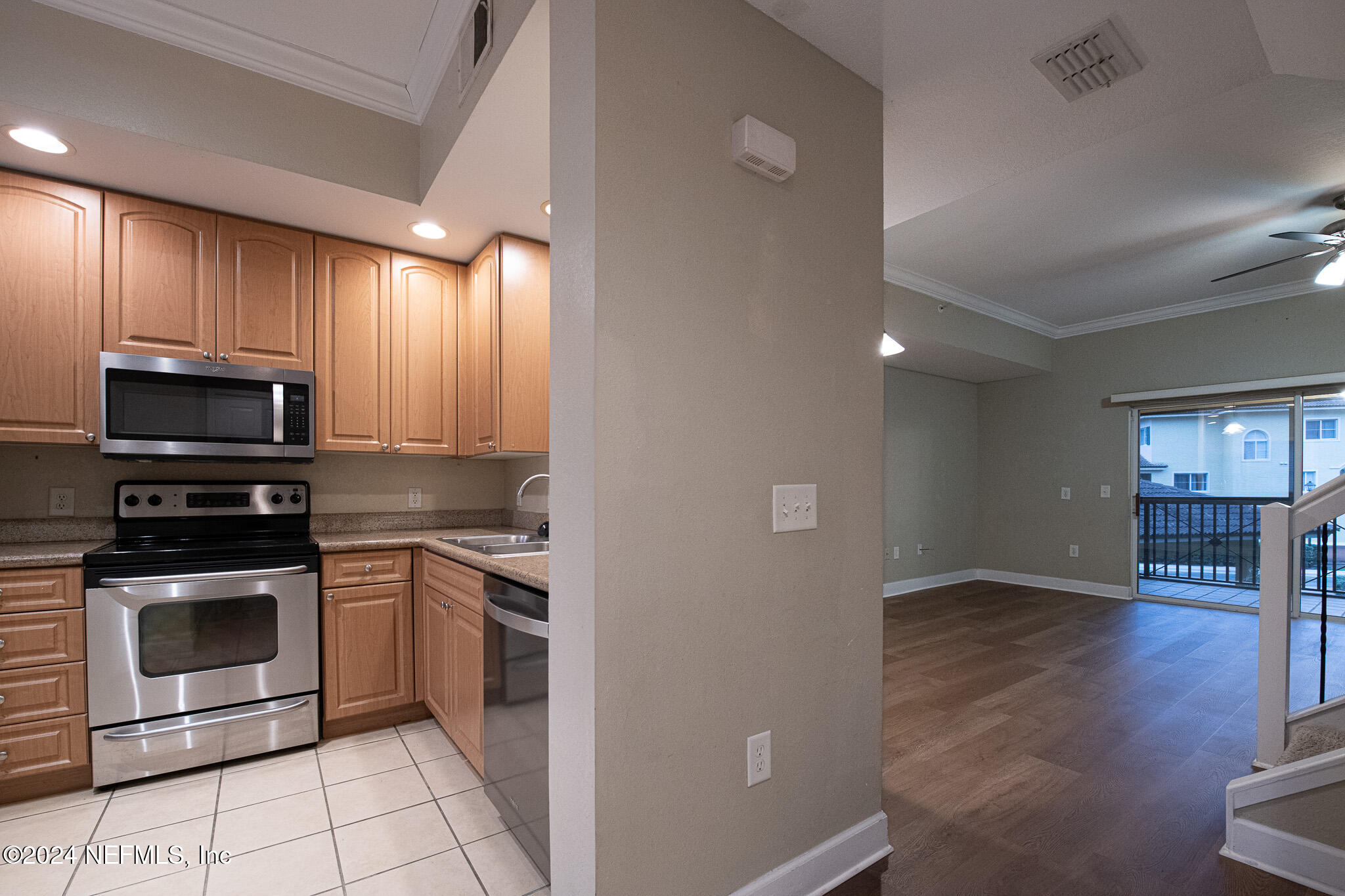 9745 Touchton Road, Unit 1922 Jacksonville, FL 32246 - Photo 2 of 26 a kitchen with granite countertop a stove top oven and cabinets