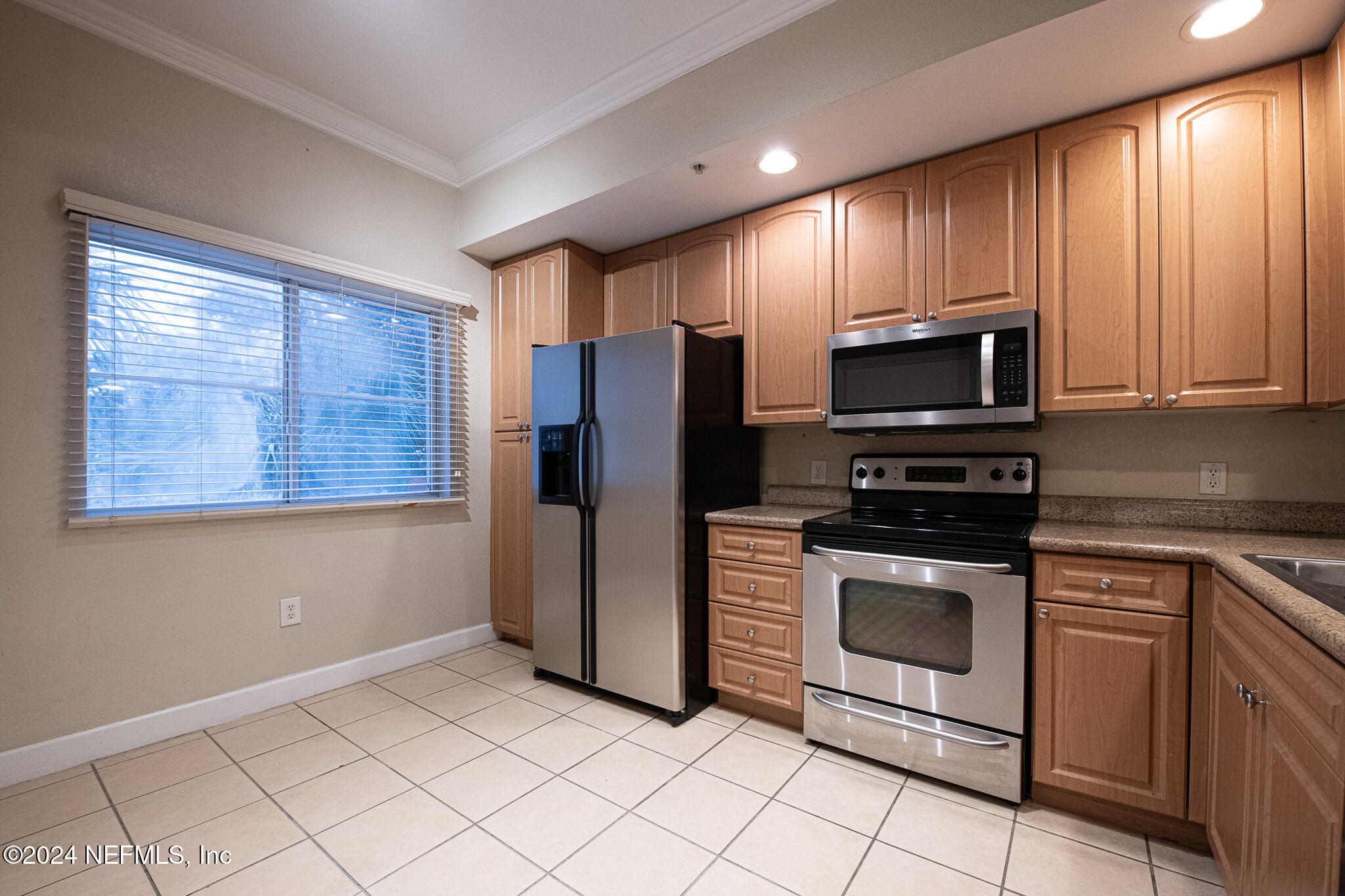 9745 Touchton Road, Unit 1922 Jacksonville, FL 32246 - Photo 3 of 26 a kitchen with stainless steel appliances granite countertop a stove a refrigerator and a microwave