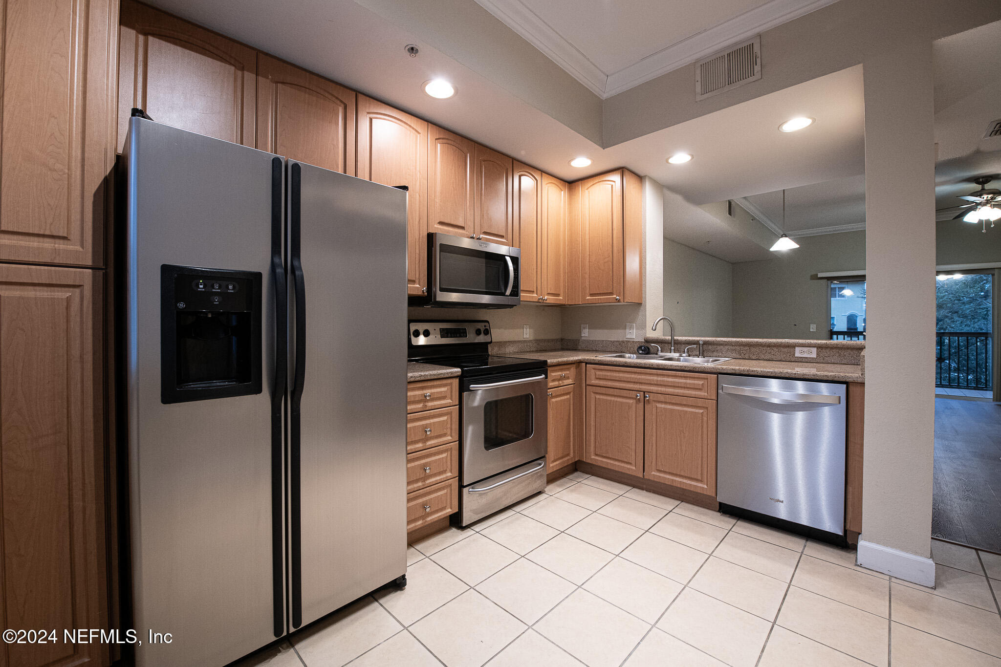 9745 Touchton Road, Unit 1922 Jacksonville, FL 32246 - Photo 4 of 26 a kitchen with stainless steel appliances a refrigerator sink and microwave