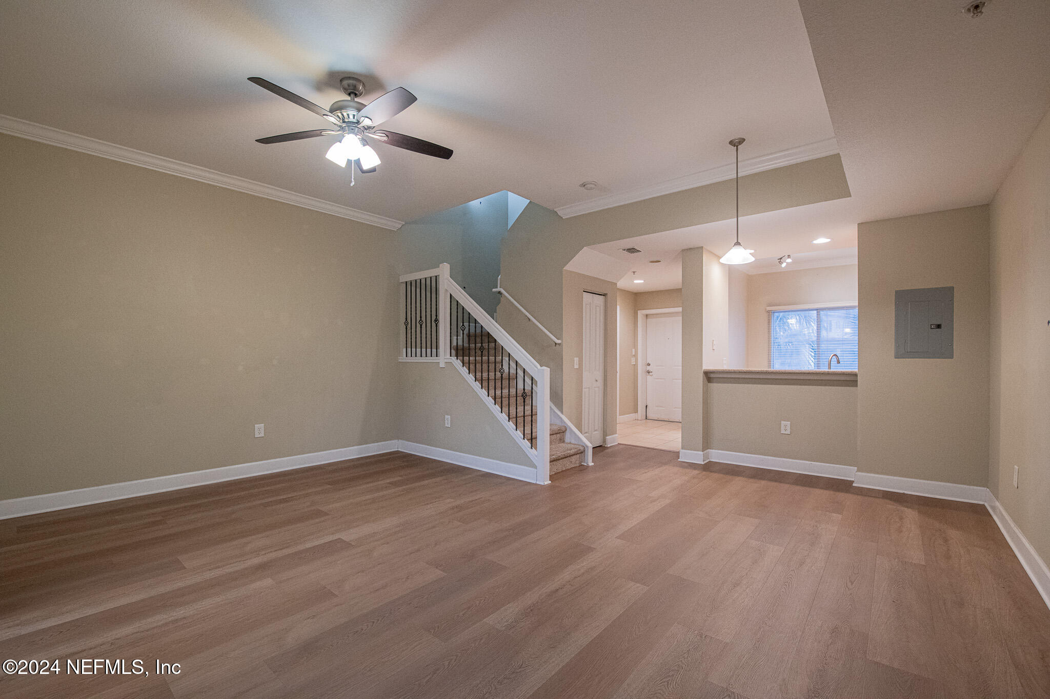 9745 Touchton Road, Unit 1922 Jacksonville, FL 32246 - Photo 7 of 26 a view of an empty room with wooden floor and a ceiling fan