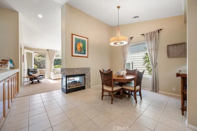 a vase of flowers sitting on a table in front of a window