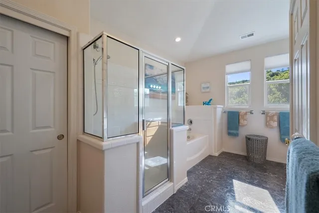 a roof deck with table and chairs under an umbrella